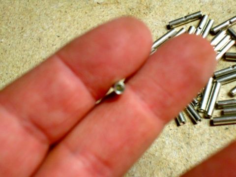 2002 Toyota 4Runner - A close-up view of electrical crimp connectors, with one held between fingers.