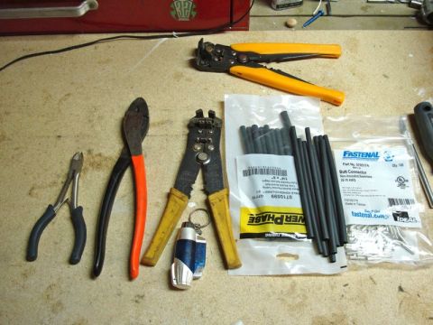 2002 Toyota 4Runner - Tools for electrical work, including wire strippers, crimpers, and heat shrink connectors, are laid out on a surface.