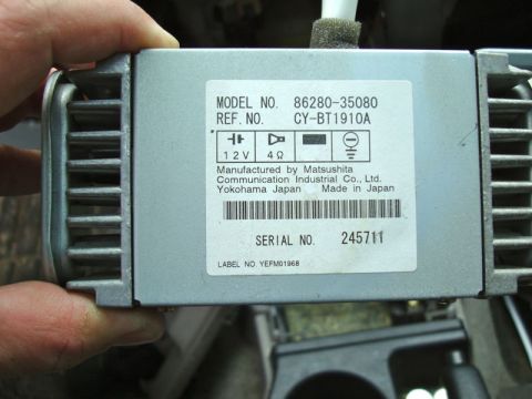 2002 Toyota 4Runner - A car stereo component, manufactured by Matsushita, is held for inspection. The part number and serial number are visible on the label.