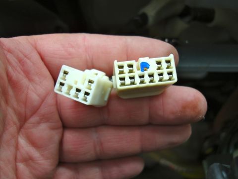 2002 Toyota 4Runner - Close-up of two car stereo wiring harness connectors being held.