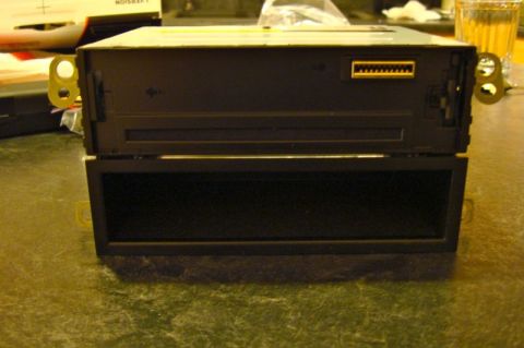 2002 Toyota 4Runner - Car stereo unit shown from the front, with a blank lower compartment and a yellow connector.