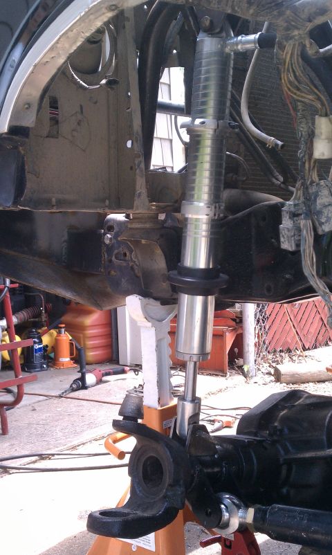 1990 Ford Bronco - Close-up of a front suspension component, likely part of a solid axle conversion, with an adjustable shock absorber installed.