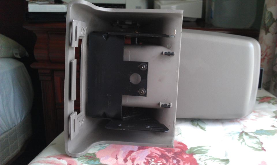 Beige car mirror housing interior with mounting bracket visible