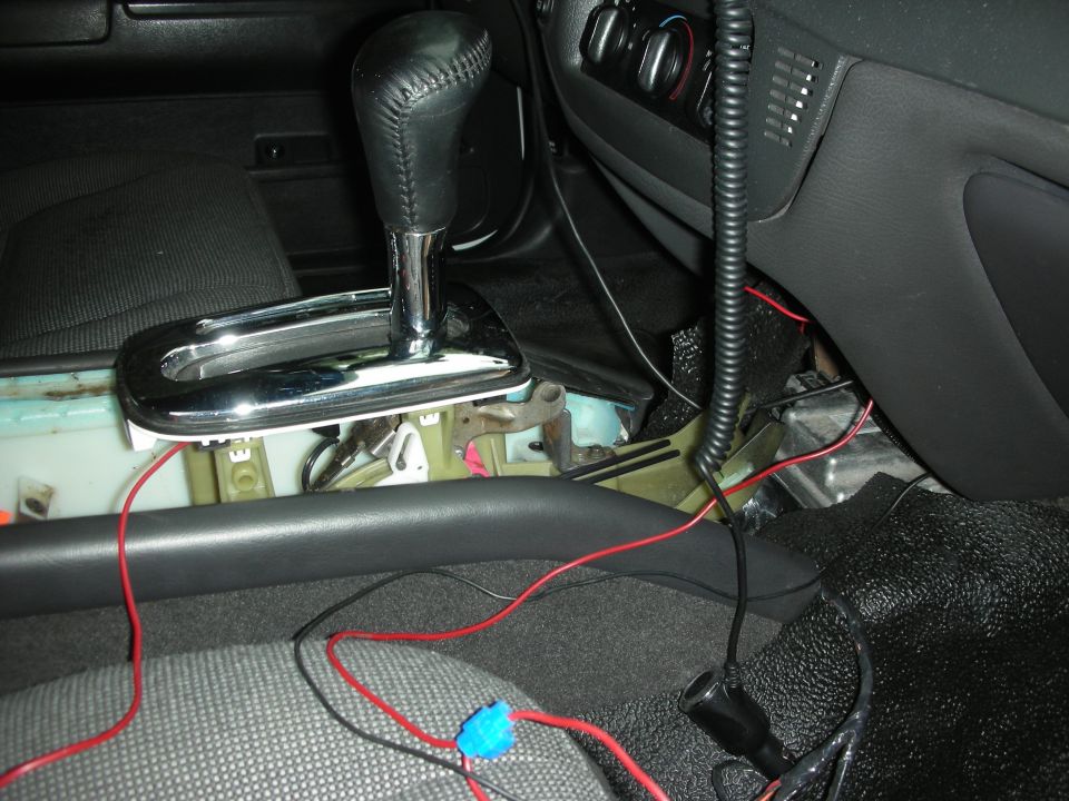 2004 Ford Crown Victoria interior showing exposed wiring and a chrome-accented gear shifter