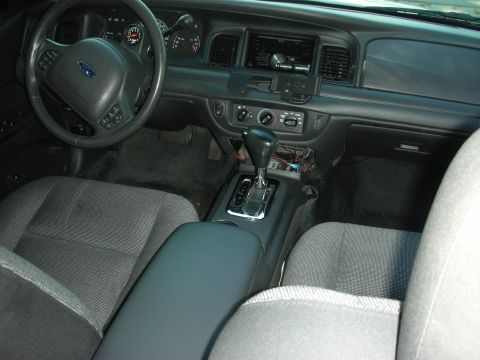2004 Ford Crown Victoria - Interior view of a 2004 Ford Crown Victoria, highlighting the dashboard and seating area.