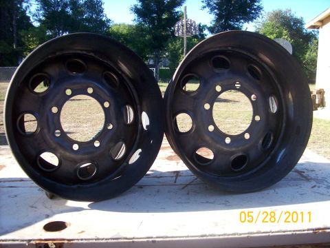 1982 Ford F-100 - A pair of black truck wheels are displayed outdoors, with a date stamp and website visible in the lower right corner.