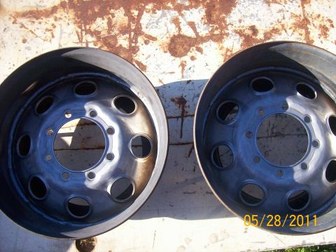 1982 Ford F-100 - Two steel truck wheels are shown against a rusty background, with a date stamp and website visible.