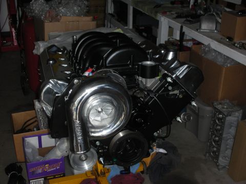 1992 Ford Crown Victoria - A V8 engine with a prominent turbocharger is displayed, likely for a custom build or modification.