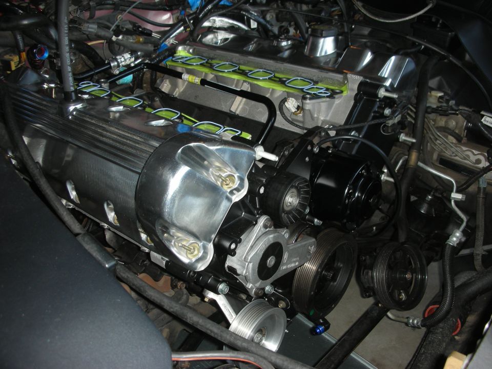 Engine bay with chrome valve covers and various pulleys and belts