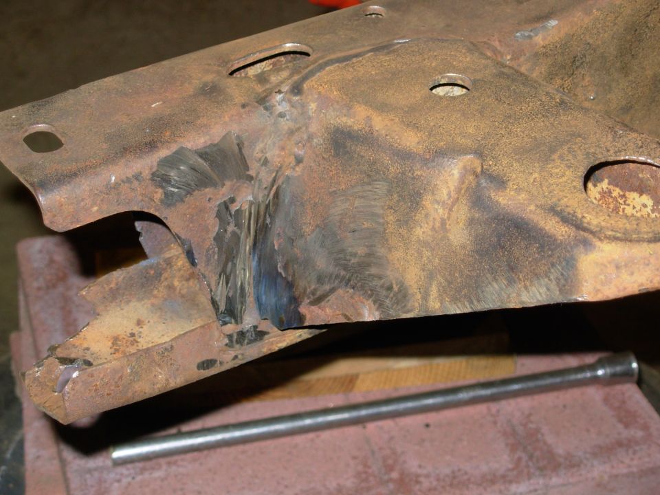 It took a few cutoff wheels & some chiselling to get the remains of the bumper off, but it's gone now.  Just some torch slag on the RHS outer.  I'll work on reshaping what's left of the factory bumper tabs.