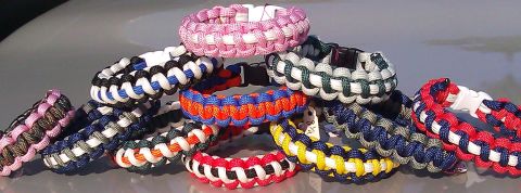 2006 Dodge Charger - A collection of woven paracord bracelets in various color combinations are displayed on a reflective surface.