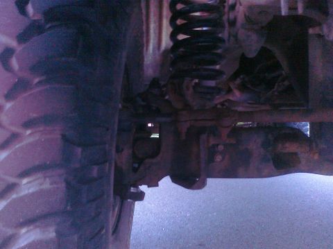 1995 Ford Bronco - Undercarriage view showing the suspension system and a large tire.
