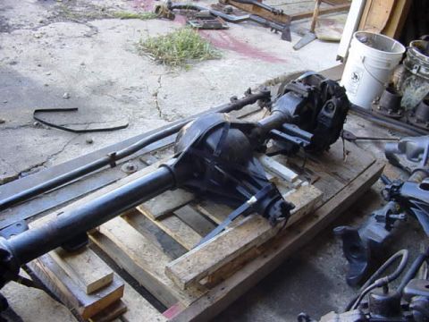 1992 Ford Bronco - A vehicle's rear axle assembly is shown resting on wooden pallets in an outdoor setting.