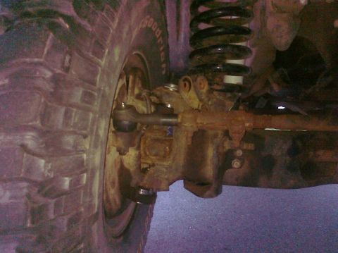 1995 Ford Bronco - Detail shot of the front suspension components and tire, with a watermark from Supermotors.net visible.