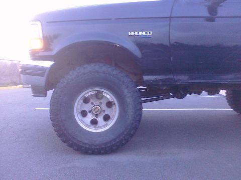 1995 Ford Bronco - Side view of a 1995 Ford Bronco showing the front wheel and fender detail.