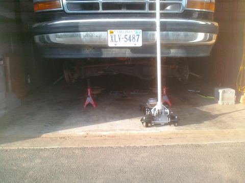 1995 Ford Bronco - Front view of a 1995 Ford Bronco being worked on, supported by jack stands.