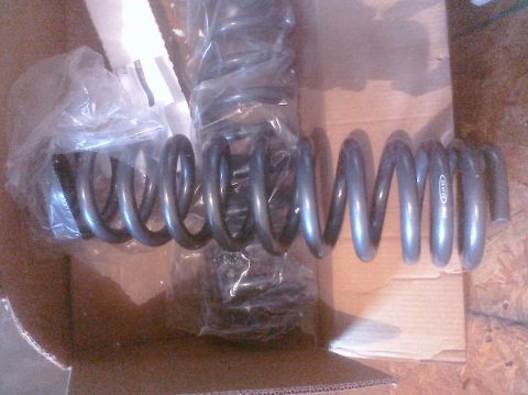 1995 Ford Bronco - New suspension coil springs are shown inside a shipping box, ready for installation.
