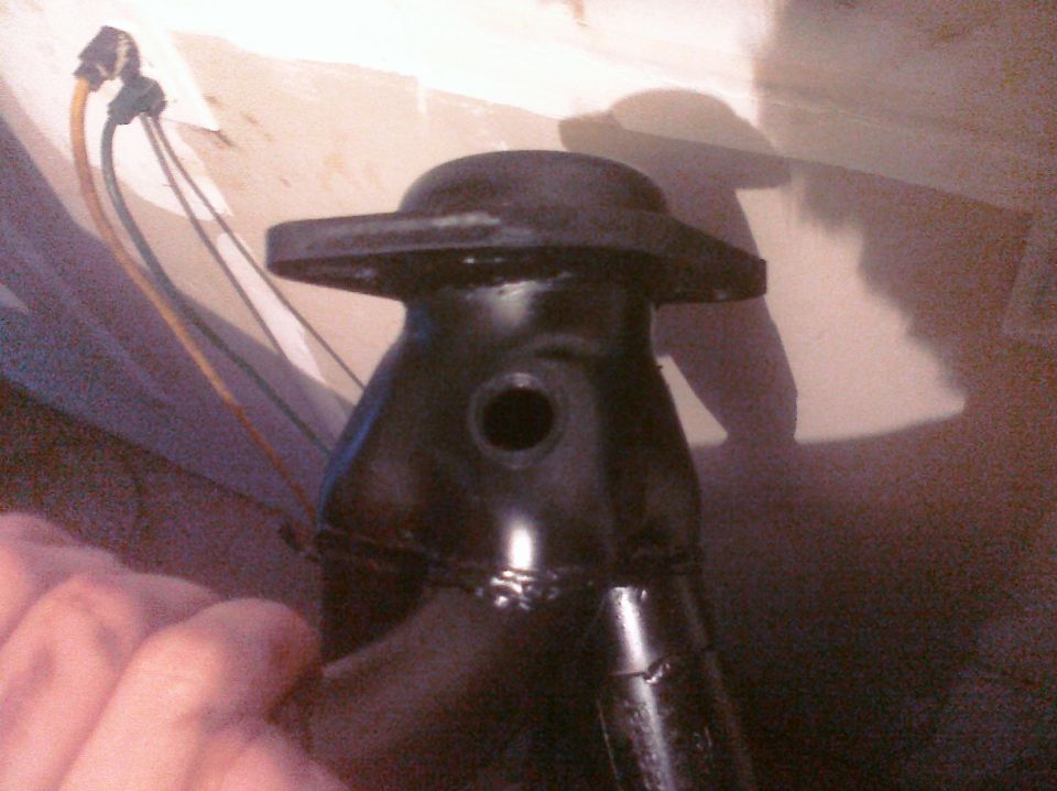 Black metal automotive part with wires attached, close-up view
