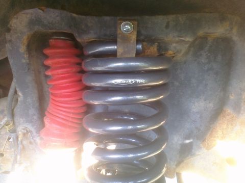 1995 Ford Bronco - The image shows a vehicle's suspension system, a coil spring with 'DEAVER F64C' visible.