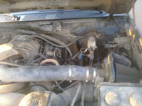 1995 Ford Bronco - Engine bay detail with aftermarket K&N air filter and brake master cylinder.