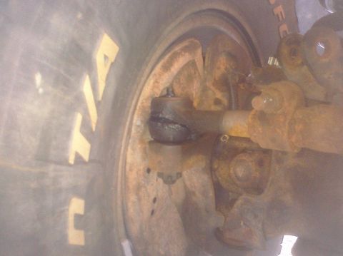 1995 Ford Bronco - Detail of a tire and rusty suspension components, likely from an older vehicle.