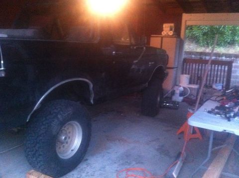 1990 Ford Bronco - This 1990 Ford Bronco is equipped with a lift kit and parked inside a garage.