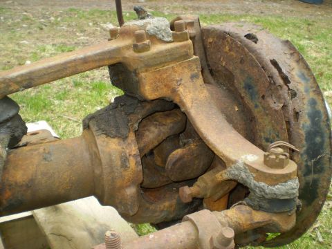 1979 Ford Bronco - This heavily rusted front axle assembly shows significant wear and corrosion on its components.