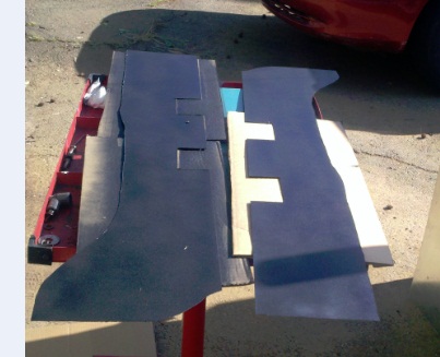 1986 Ford Bronco - Carpet cutouts laid out on a table, possibly for installation or pattern making.
