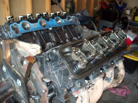1985 Ford Bronco - Close-up view of a V8 engine's internal components, including the valve train and exhaust manifolds.