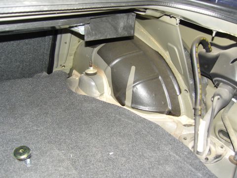2007 Ford Mustang - The interior of a vehicle's trunk, showing the carpeted floor and the suspension mounting points.