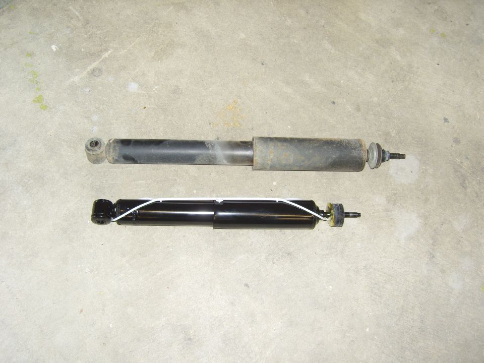 old shock absorber above new black shock absorber