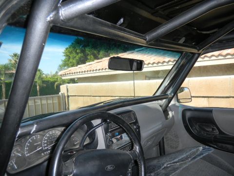 1997 Ford Ranger - Interior view of a 1997 Ford Ranger, a custom roll cage and aftermarket audio equipment.