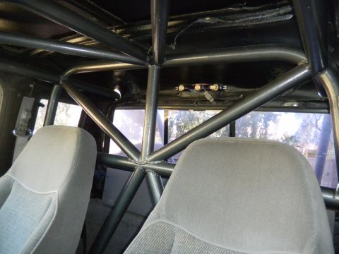 1997 Ford Ranger - The interior of the truck shows a custom roll cage installed over the seats and headliner.