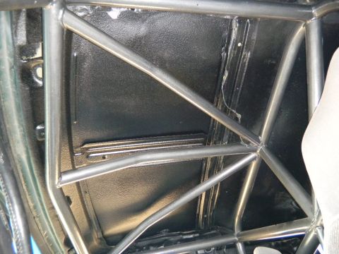 1997 Ford Ranger - Interior view of a vehicle's roll cage structure, showing metal tubing against a black background.
