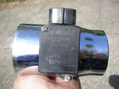 1990 Ford Bronco - A Pro-M Racing Mass Air Sensor is held in a hand, showing the part number and calibration information.