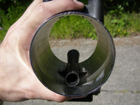 1990 Ford Bronco - A person holds a mass air flow sensor, showing the internal components and the opening.