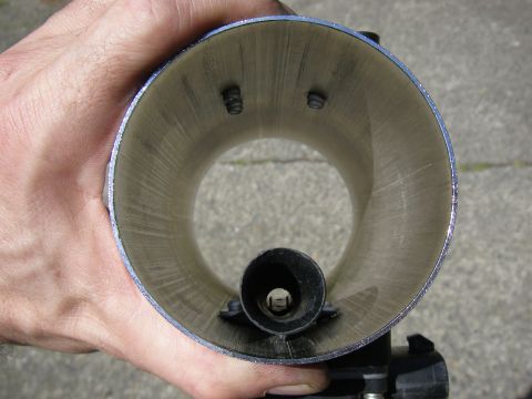 1990 Ford Bronco - A hand holds a mass air sensor housing, revealing its internal components and textured interior.