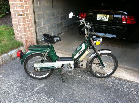 1981 Garelli Rally Sport - A green Garelli moped is parked in a garage, with a black car visible in the background.
