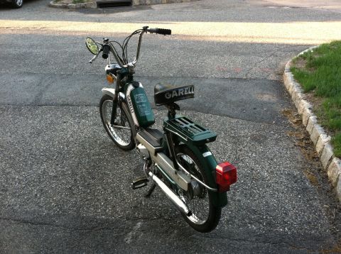 1981 Garelli Rally Sport - This green Garelli moped is shown from a 3q-front perspective, with the brand name clearly visible on its seat.