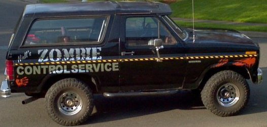Black Ford Bronco with 'Hall's ZOMBIE CONTROL SERVICE' text and graphics on the side