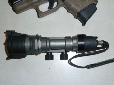 1992 Ford Mustang - Tactical flashlight and pistol grip shown together on a flat surface.