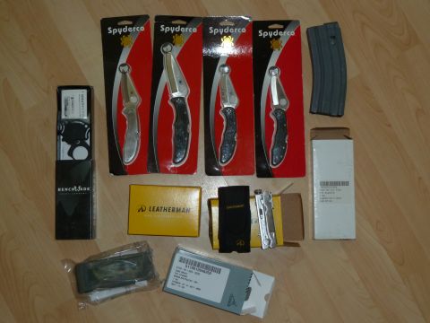 1992 Ford Mustang - A collection of knives, multi-tools, and a rifle magazine are displayed on a wooden surface.