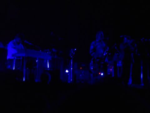 1989 Ford Bronco - Stage performance with musicians playing instruments under blue lighting.