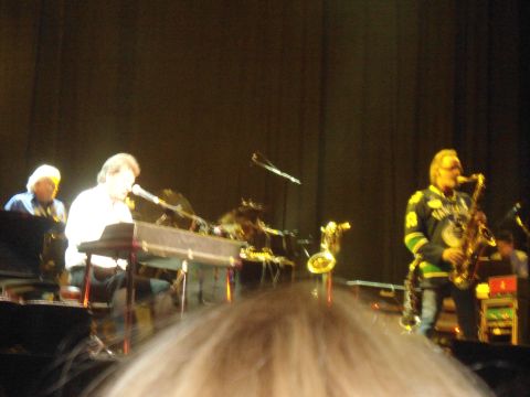 1989 Ford Bronco - A band performs live on stage, with a keyboardist and a saxophonist visible.