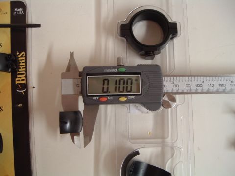 1995 Mercury Grand Marquis - A digital caliper measures a small black part, indicating a precise dimension of 0.100 inches.