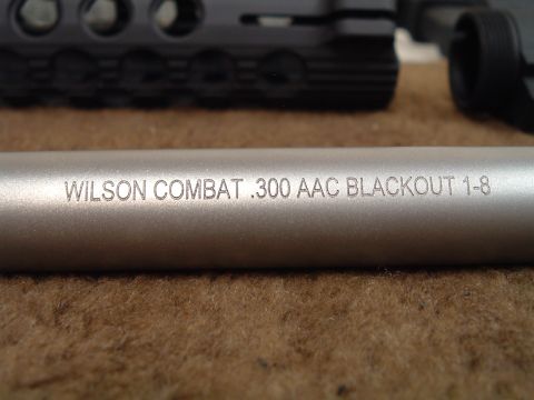 1995 Mercury Grand Marquis - Close-up of a gun barrel showing the caliber marking "WILSON COMBAT .300 AAC BLACKOUT 1-8".