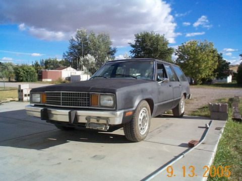 1982 Mercury Zephyr - A weathered station wagon sits on a concrete driveway under a cloudy sky.