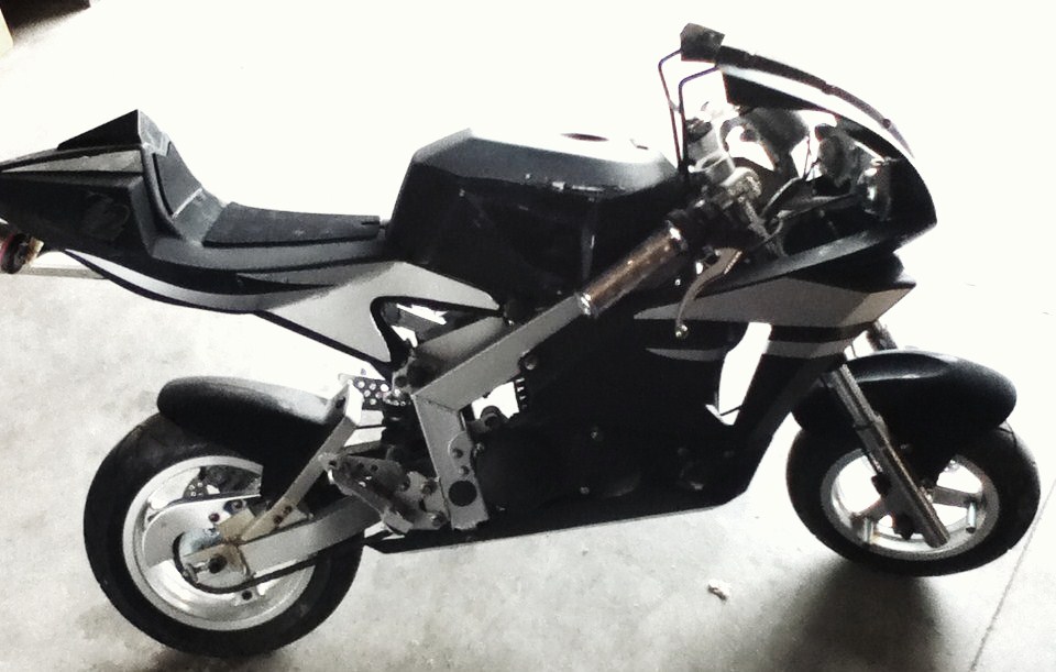 Side view of a black and silver sport motorcycle with a low seat and small wheels