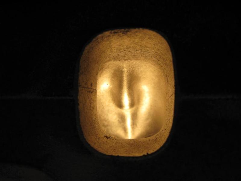 Headlight assembly with internal filament glowing yellow, against a black background