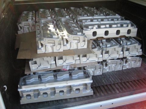 1972 Ford Ranchero - Multiple engine cylinder heads are loaded in the bed of a truck.